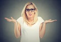 Portrait dumb looking woman arms out shrugs shoulders I don`t know. Negative emotion body language Royalty Free Stock Photo