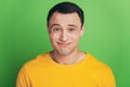 Portrait of dumb unsure guy shrug shoulders clueless face on green background