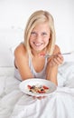 Portrait, eating and woman with breakfast in bed with healthy food, fruit and oats for nutrition in diet. Happy, girl Royalty Free Stock Photo