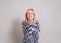 Portrait of ecstatic young woman in eyeglasses laughing and blowing a kiss over white background Royalty Free Stock Photo