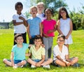 Portrait of eight children who are walking and posing in the park Royalty Free Stock Photo