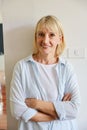 Portrait elder caucasian woman, golden and short hair in blue and white shirt