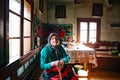 Portrait of an elder woman in traditional old home and traditional clothes, Roumania Maramures County