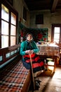 Portrait of an elder woman in traditional old home and traditional clothes, Roumania Maramures County