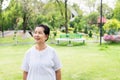 Portrait of a elderly asian woman standing and looking something at park,Happy and smiling