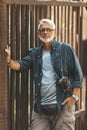 Portrait of an elderly bearded citizen with glasses. Active lifestyle and retirement tourism