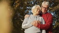portrait of elderly Caucasian couple woman looking at her husband, man looking down covering his wife's hand with Royalty Free Stock Photo