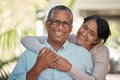 Portrait of an elderly couple hugging and bonding outdoors, happy and relaxing in a yard or garden together. Senior man Royalty Free Stock Photo