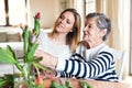 Elderly grandmother with an adult granddaughter at home.