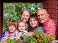 Portrait of elderly grandparents with three granddaughters on  porch of  village house Royalty Free Stock Photo