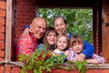 Portrait of elderly grandparents with three granddaughters on  porch of  village house Royalty Free Stock Photo