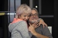 Portrait of an elderly happy and laughing couple of 60-65 years indoors on a blurred background. Concept: Love for life, family re Royalty Free Stock Photo