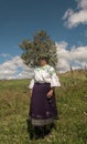 Portrait of elderly indigenous woman from Cayambe walking through the field during the day