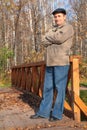 Portrait of elderly man in black hat in wood Royalty Free Stock Photo