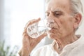 Portrait elderly man drinking water