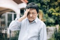 Portrait of an elderly man with headache.senior man covering his face with his hands.vintage tone