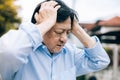 Portrait of an elderly man with headache.senior man covering his face with his hands.vintage tone