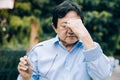 Portrait of an elderly man with headache.senior man covering his face with his hands.vintage tone Royalty Free Stock Photo