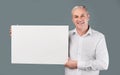 Portrait of elderly man holding blank white placard Royalty Free Stock Photo