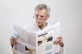 Portrait elderly man reading newspaper