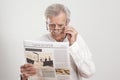 Portrait elderly man reading newspaper