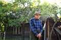 Portrait of elderly man standing outdoors in garden, resting. Royalty Free Stock Photo