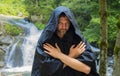 Portrait of an elderly monk 35-40 years old with a beard in a black cassock, arms crossed on his chest, against the background of Royalty Free Stock Photo