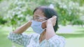 Portrait of Elderly old Asian woman taking off face mask in the park after The epidemic situation resolved after There are