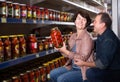 Portrait of an elderly couple buying a salted tomatoes at the grocery store Royalty Free Stock Photo