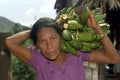 Portrait of elderly woman carrying plantains