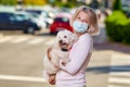 Portrait elderly woman with a dog outdoors an antivirus mask Royalty Free Stock Photo
