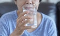 Portrait Elderly woman drinking glass of water to retirement i Royalty Free Stock Photo