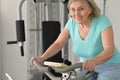 Elderly woman exercising in gym Royalty Free Stock Photo