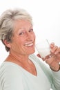 Elderly woman with a glass of milk