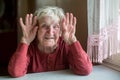 Portrait of an elderly happy woman playful with a kind face.