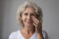 Portrait of elderly woman use nourishing facial cream