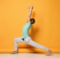 oga man. Man doing yoga on a yellow background