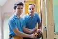 Portrait Of Electrician With Apprentice Working In New Home Royalty Free Stock Photo