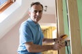 Portrait Of Electrician Installing Socket In New House Royalty Free Stock Photo