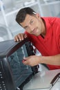 Portrait electrician repairing worktop oven