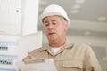 Portrait electrician standing next to fuseboard Royalty Free Stock Photo