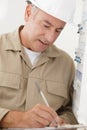 Portrait electrician standing next to fuseboard Royalty Free Stock Photo
