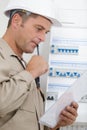 Portrait electrician standing next to fuseboard Royalty Free Stock Photo