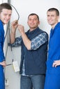 Portrait electrician with two apprentices