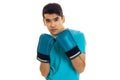 Portrait of elegance sportsman in blue gloves and uniform practicing boxing on camera isolated on white background Royalty Free Stock Photo