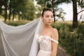 Portrait of elegand bride with bouquet. Young bride outdoors