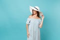 Portrait of elegant fashion beautiful young woman in white summer large wide brim sun hat, dress put hands on head Royalty Free Stock Photo