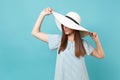 Portrait of elegant fashion beautiful young woman in white summer large wide brim sun hat, dress put hands on head Royalty Free Stock Photo