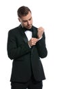 Portrait of elegant fashion man in tuxedo adjusting sleeve Royalty Free Stock Photo