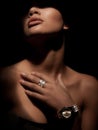 Portrait of an elegant woman with luxury wide rings made from precious metals on her finger and watch on wrist Royalty Free Stock Photo